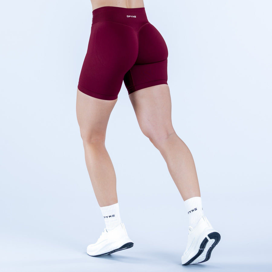 6.5-inch maroon athletic impact shorts, side view with curved seam detail.