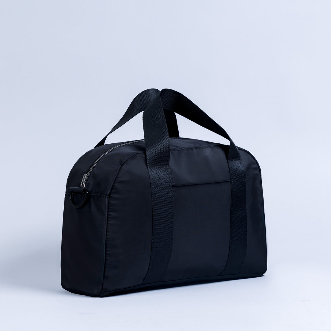 Dark mini duffle bag with top handles and front zip pocket