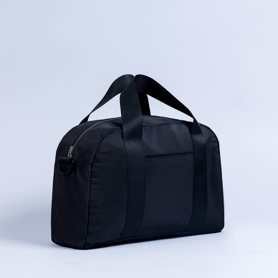 Dark mini duffle bag with top handles and front zip pocket