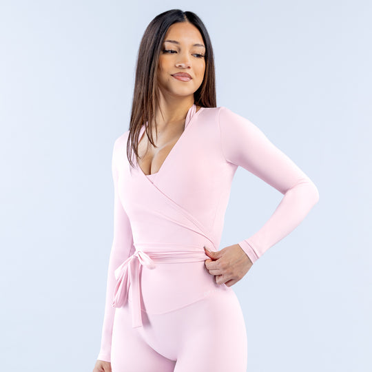 Pink long-sleeve wrap top with V-neck and waist tie
