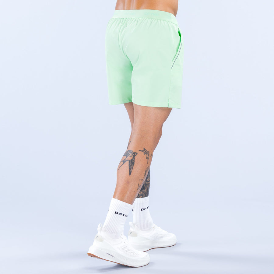Light green training shorts, rear view with elastic waistband and 6-inch inseam