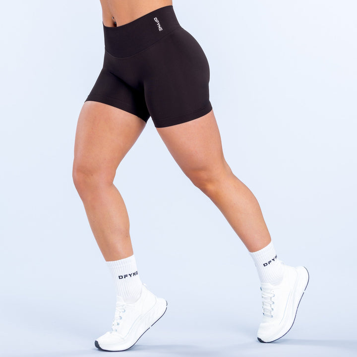 Defy 4.5-inch compression shorts, black fitted mid-thigh with small waistband logo