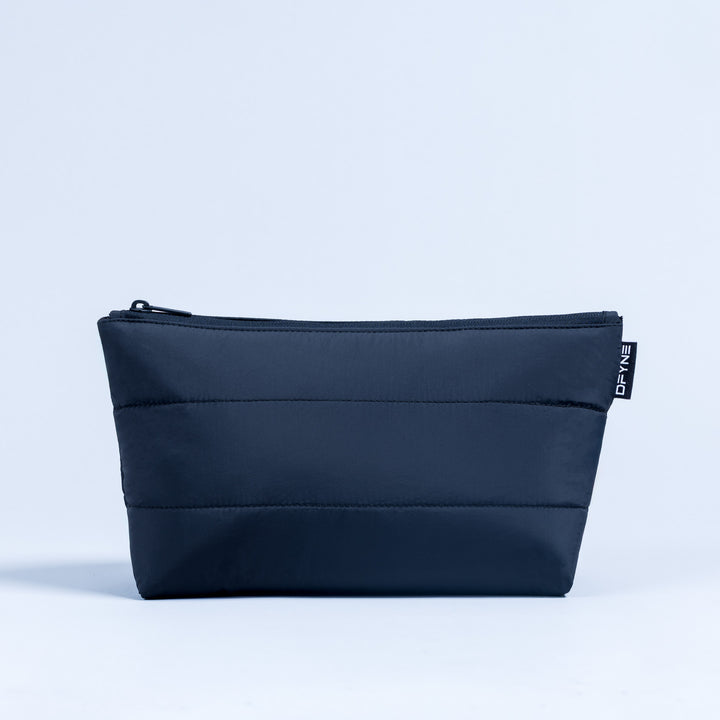 Dark navy rectangular zip pouch with front horizontal quilting and logo label tab