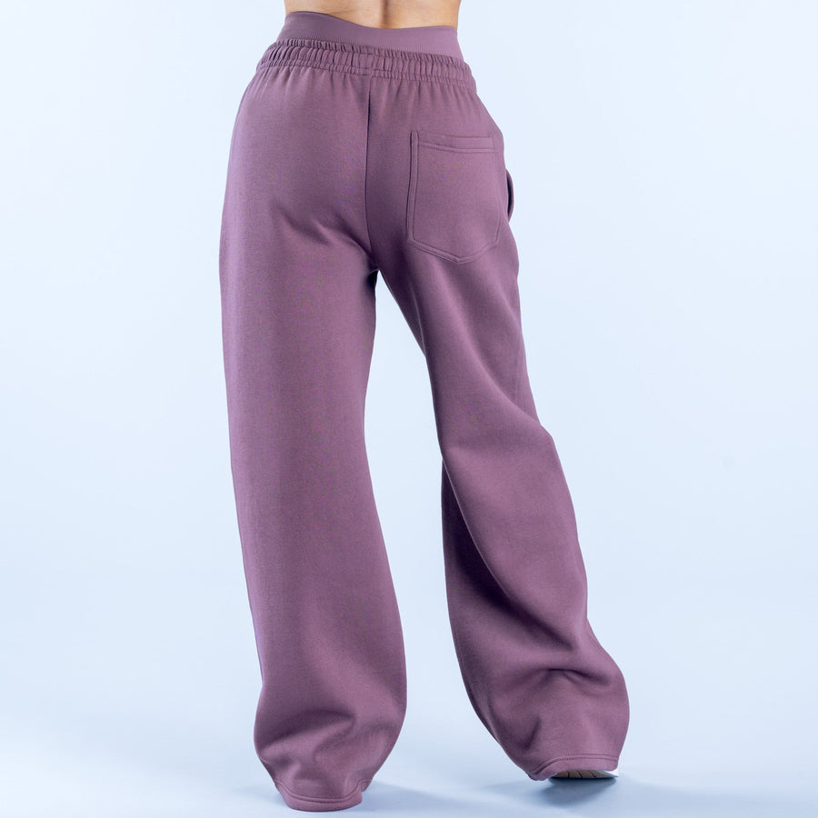 Purple wide-leg jogger pants with elastic waistband and relaxed back fit