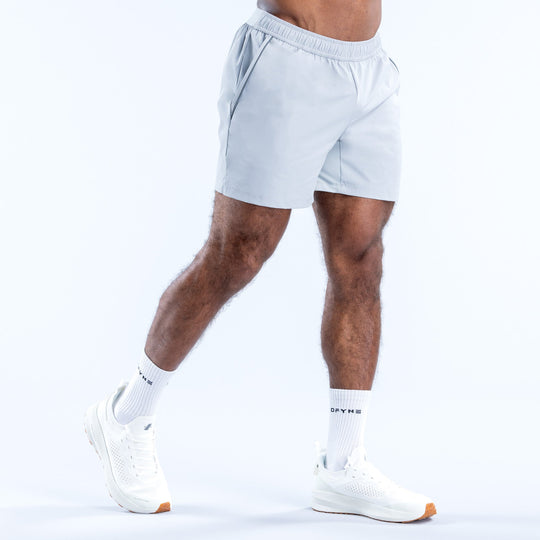 Light blue training shorts, side view, elastic waistband and logo at hem