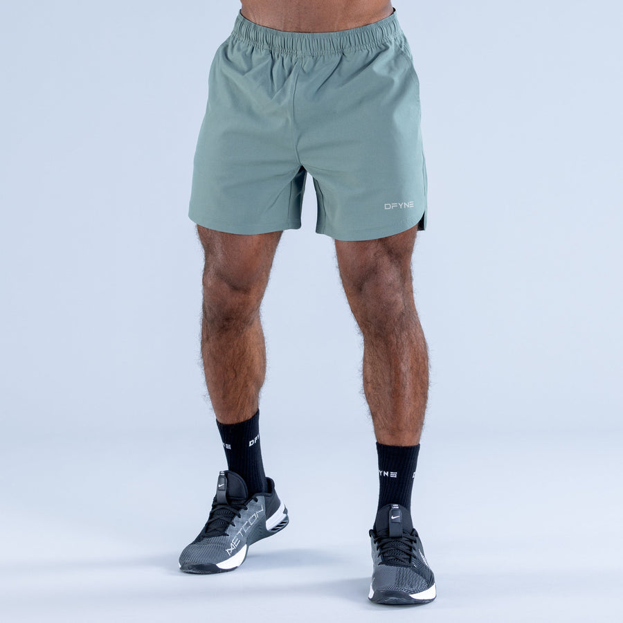 Teal training shorts with elastic waistband, small DPYNE logo on front
