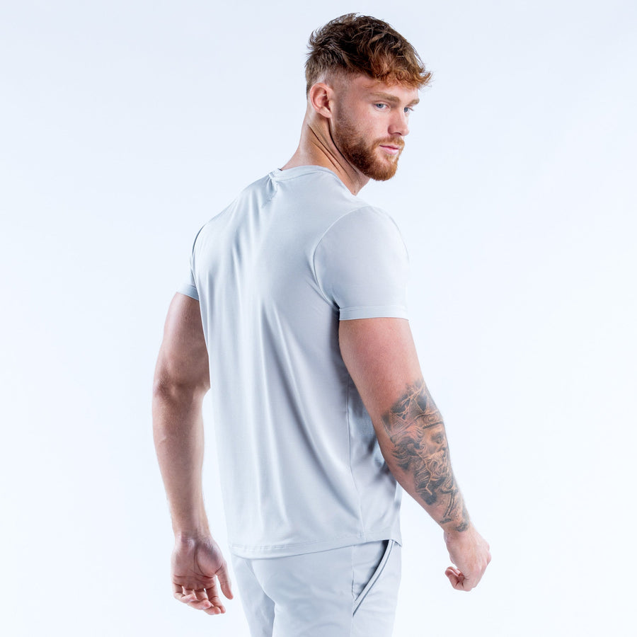 Light blue performance crew-neck T-shirt side view, short sleeves and curved hem