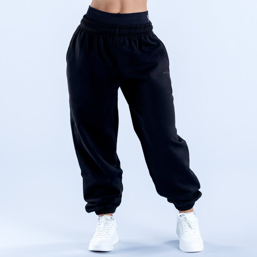 Dark jogger pants with gathered elastic waistband and tapered legs