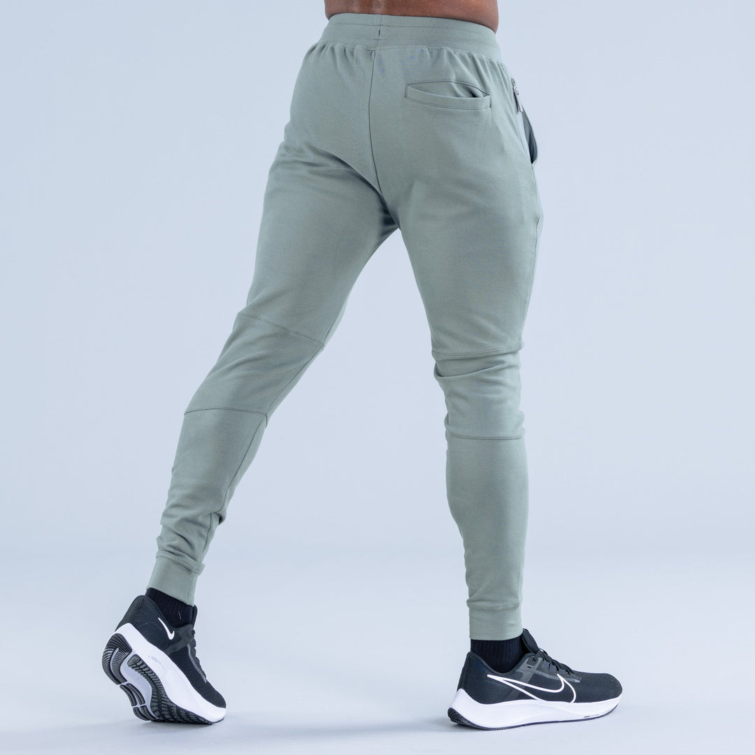 Sage green tapered jogger pants, back view with back pocket and drawstring waistband