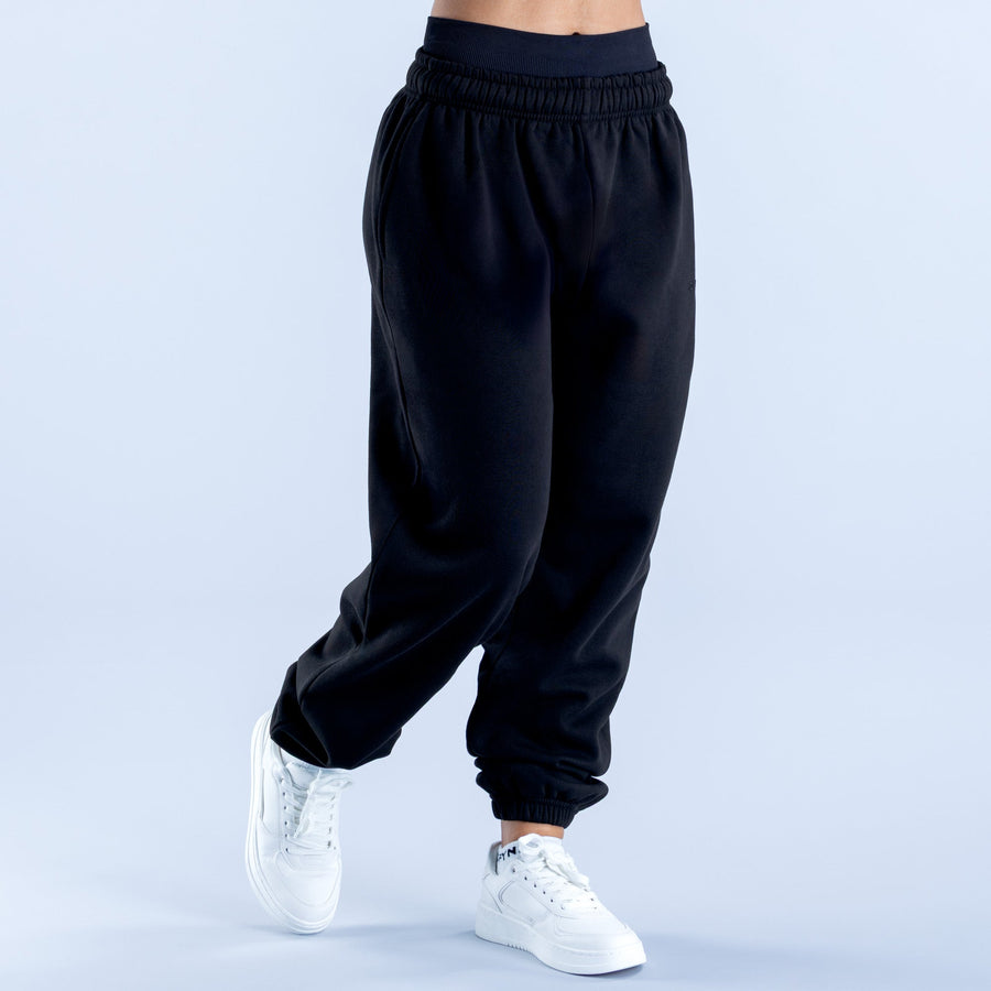 Dark jogger pants with elastic waistband, roomy legs, and cuffed hems