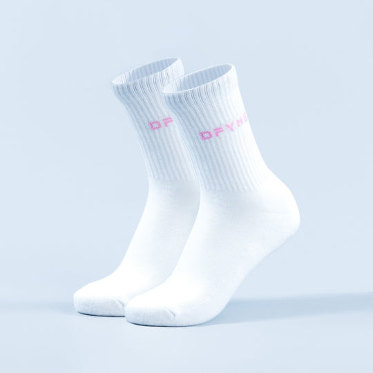 Pair of white crew socks with pink logo lettering on the ankle