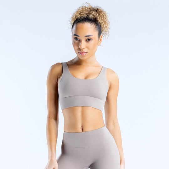 Light gray sports bra with wide racerback straps and scoop neckline
