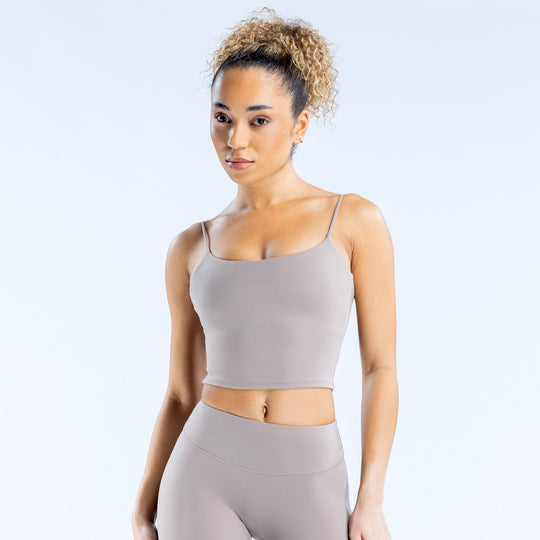 Gray strappy cropped tank top with thin spaghetti straps and straight neckline