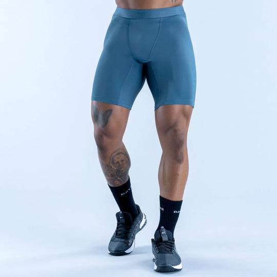 Unbound baselayer shorts in teal, side view with flat waistband and smooth finish