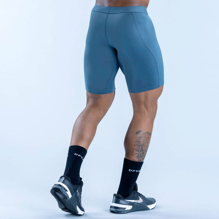 Unbound baselayer shorts in teal, rear view with contoured seams