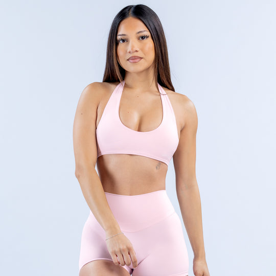 Pink halter bra with scoop front neckline and open-back design