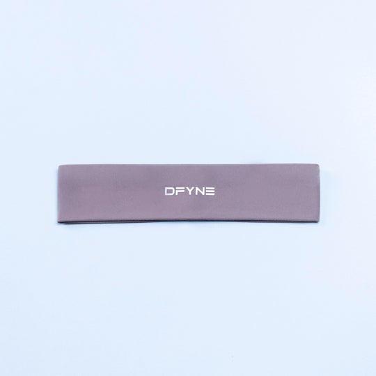 Mauve Origin headband with DFYNE logo, flat lay.