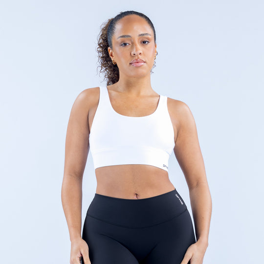 Origin sports bra in white with wide scoop neckline and racerback straps