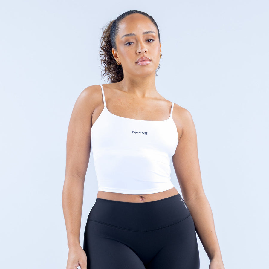 White strappy sports crop top with thin straps and square neckline, small chest logo