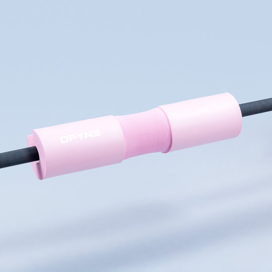 Barbell pad with foam sleeve, pink cover, and snug fit for standard barbells