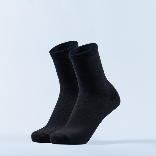 Pair of black crew socks with ribbed knit and smooth cuffs.