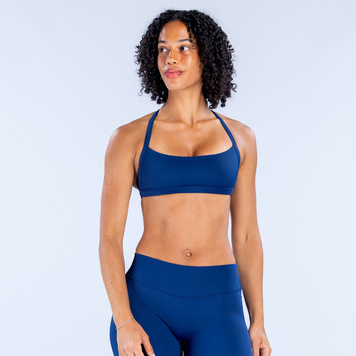 Blue sports bra with scoop neckline and elastic underband.