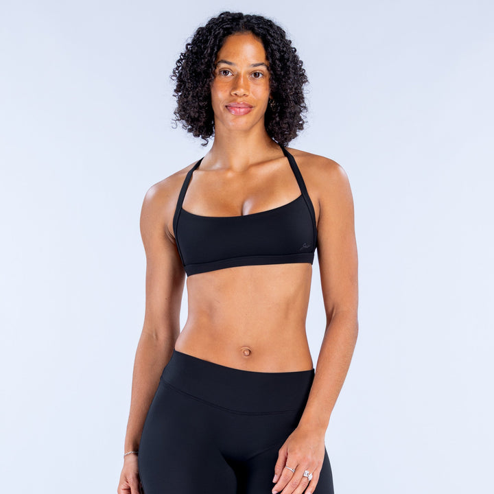 Front view of a black sports bra with wide straps and smooth cups