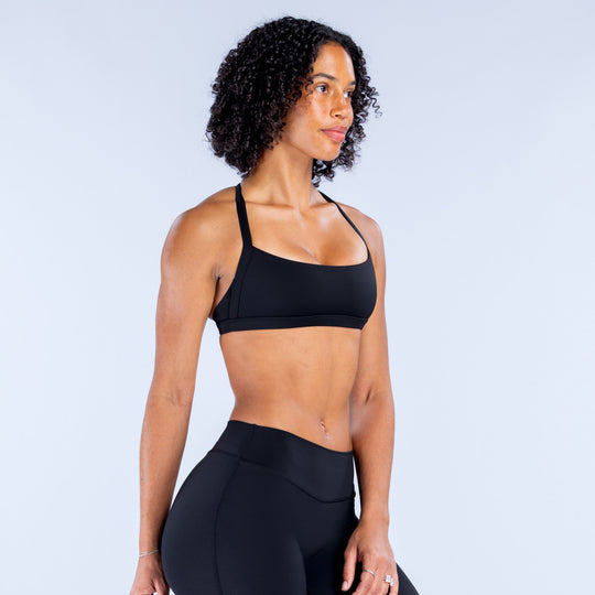 Black sports bra with thin straps and a square neckline