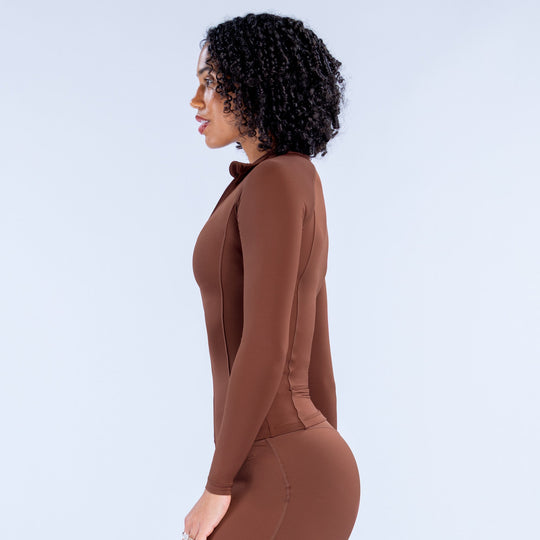 Brown zip-front athletic bodysuit with long sleeves and fitted torso