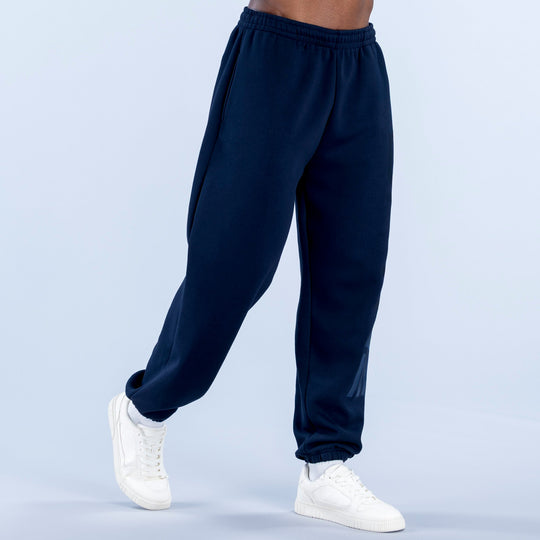 Navy cuffed jogger pants with elastic waistband and tapered cuffed hems