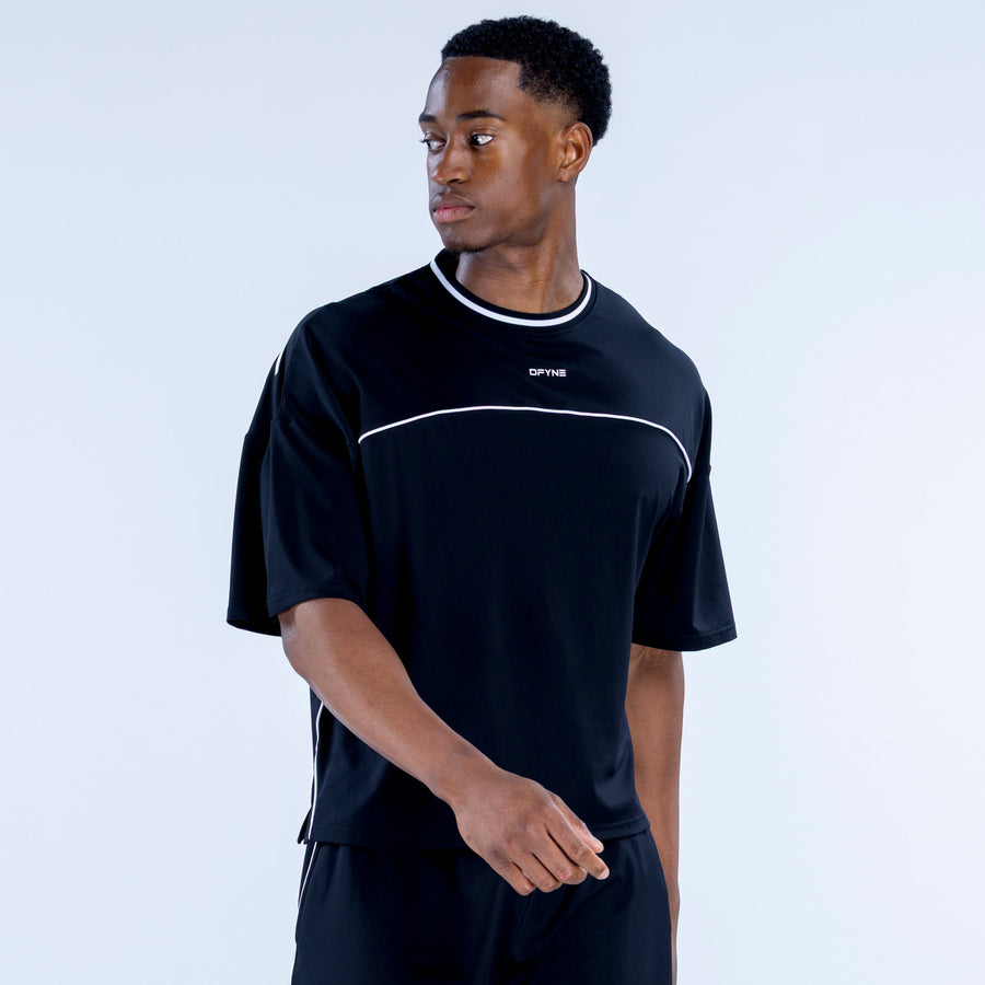 Black short-sleeve jersey with white crew-neck trim and chest logo; side view