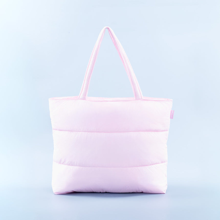 Light pink puffer tote bag with quilted panels and two top handles