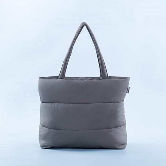 Gray padded tote bag with rounded handles and quilted front panel