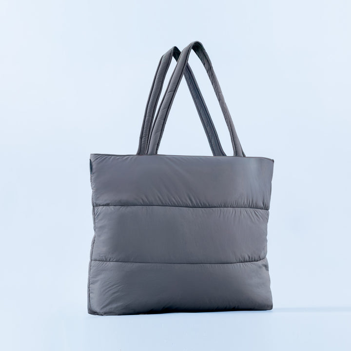 Gray puffer tote bag with two top handles and quilted horizontal baffles