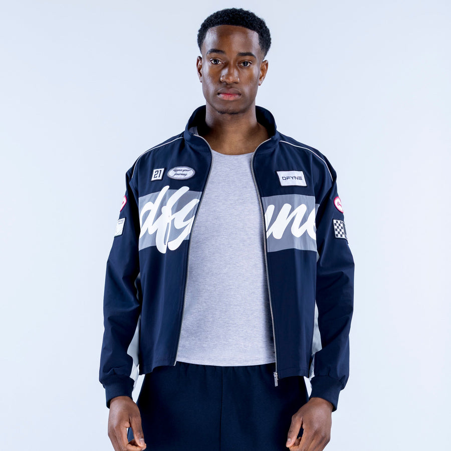 Men's navy track jacket with white script graphics on chest, zip front