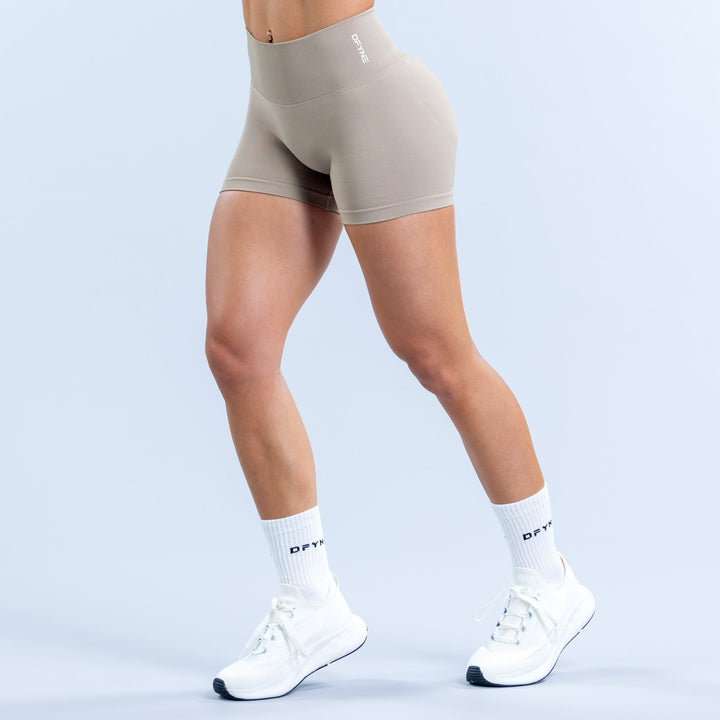 Light taupe fitted athletic shorts with 4.5-inch inseam and small side logo