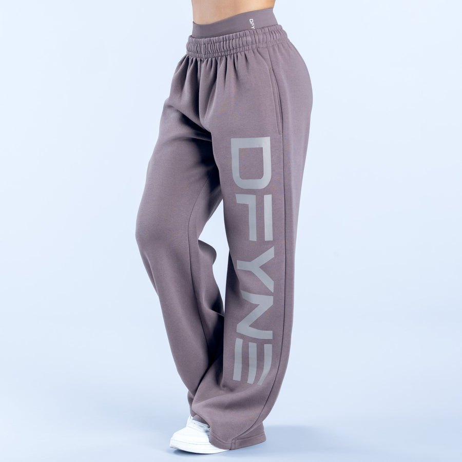 Taupe wide-leg joggers with elastic waist and large 'DENY' side graphic