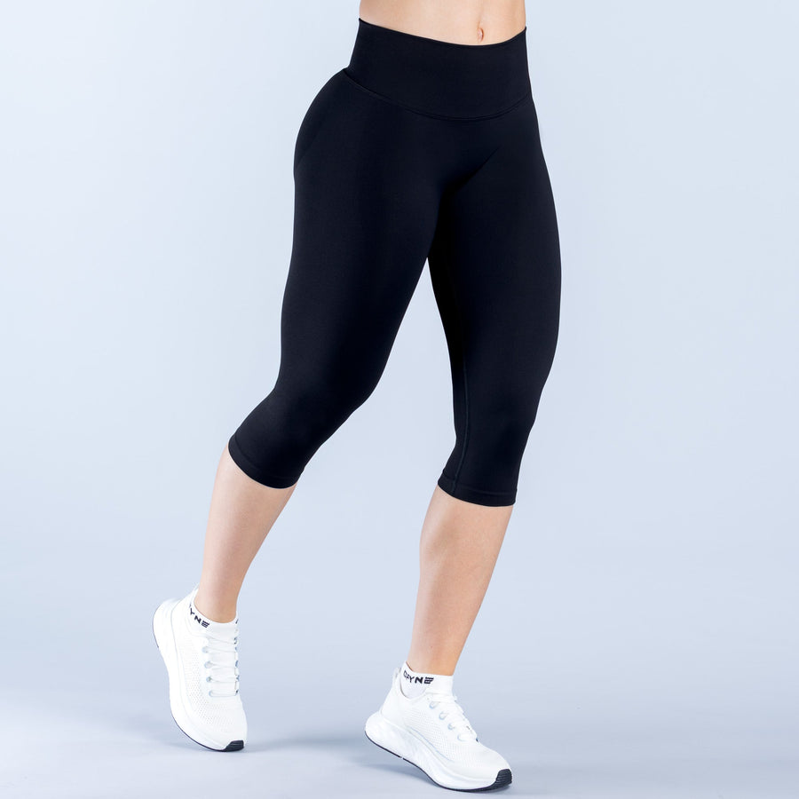 Black 3/4 capri leggings with straight waistband, smooth slim-leg fit.